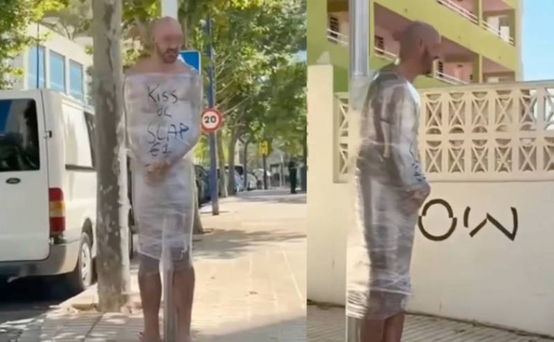 <span style='color:#780948'>ARCHIVED</span> - Drunken Brit antics: Naked man wrapped in cling film and tied to lamppost in Benidorm, Spain